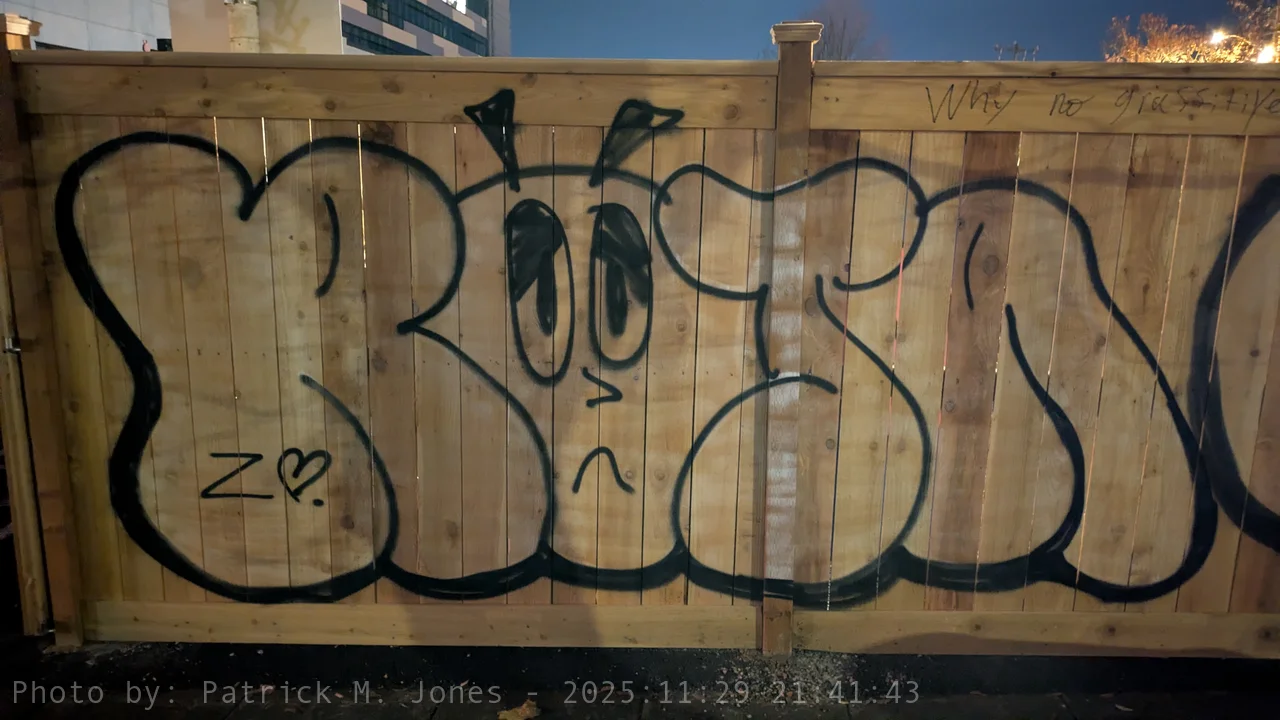 Sad Roja on Wooden Fence